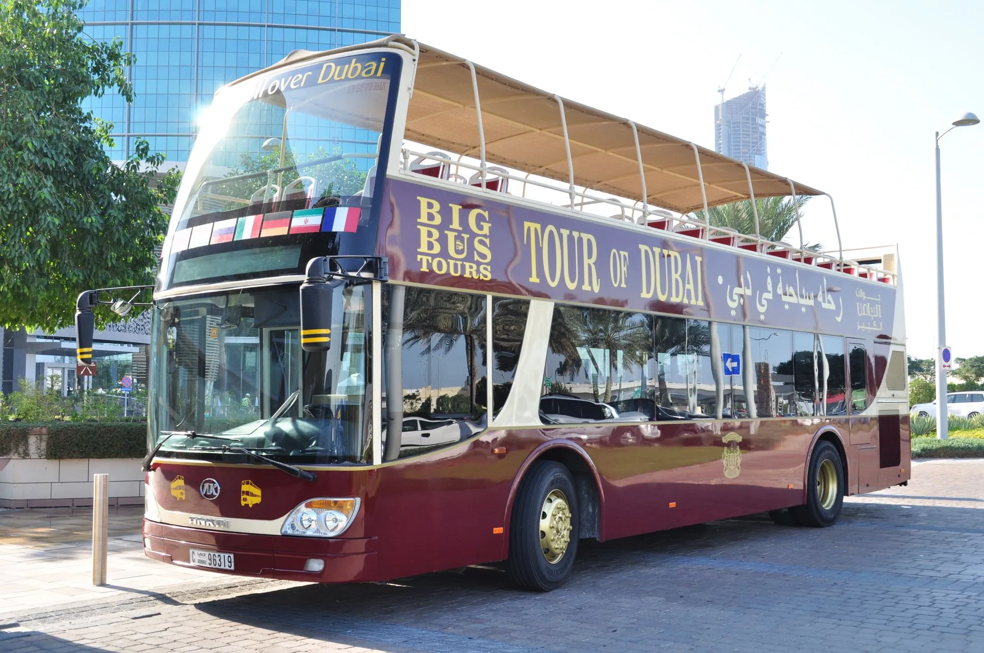 A Big Bus Tours open-top double-decker sightseeing bus parked on a Dubai street in bright sunshine