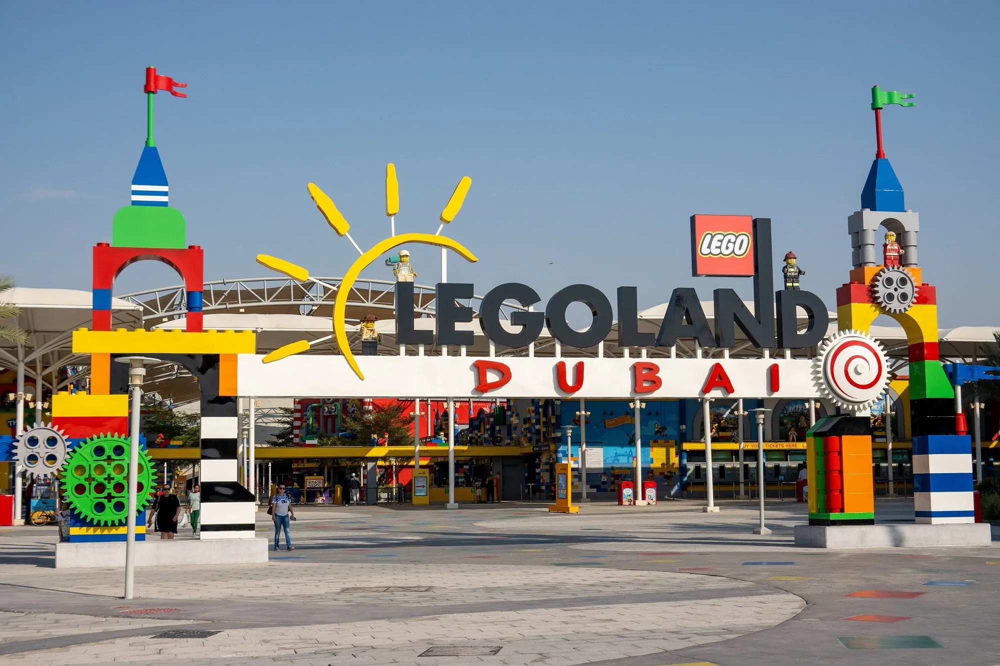 The brick-built LEGOLAND Dubai entrance gateway with colourful LEGO towers under a clear blue sky
