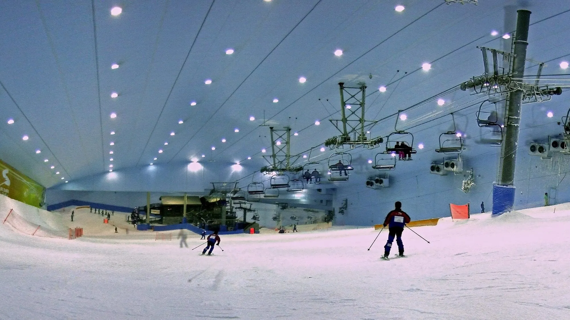The indoor snow slope at Ski Dubai with chairlift and skiers beneath the lit ceiling, Mall of the Emirates